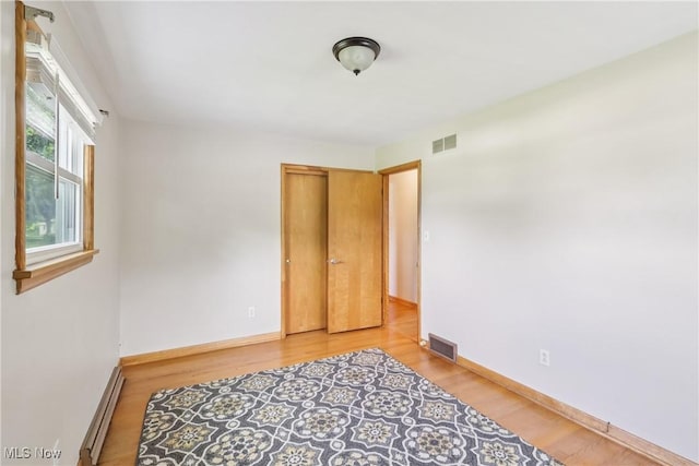 1455 Buckeye Cir, Salem, OH 44460 - bedroom with baseboard heating and wood finished floors