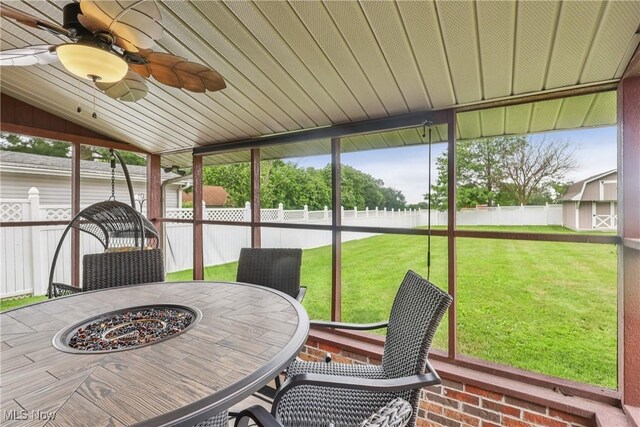 1455 Buckeye Cir, Salem, OH 44460 - sunroom / solarium with lofted ceiling, ceiling fan, outdoor dining space, and a fire pit