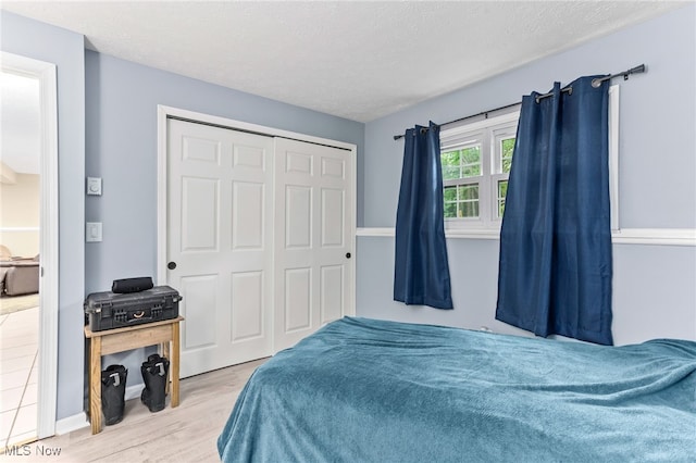 845 Dunny Ave, Sheffield Lake, OH 44054 - bedroom featuring wood finished floors, a closet, and a textured ceiling