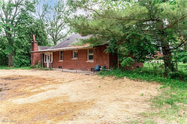 9509 Reed Rd, Columbia Station, OH 44028 - view of side of property with a chimney and brick siding