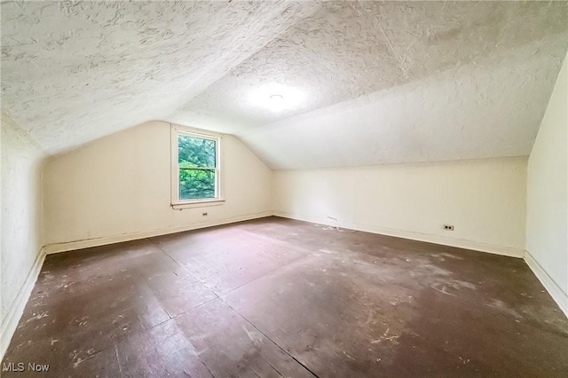 9509 Reed Rd, Columbia Station, OH 44028 - additional living space with lofted ceiling and a textured ceiling