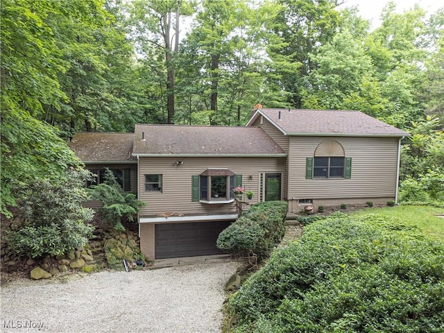 3366 Darrow Rd, Stow, OH 44224 - tri-level home featuring gravel driveway, a garage, and roof with shingles