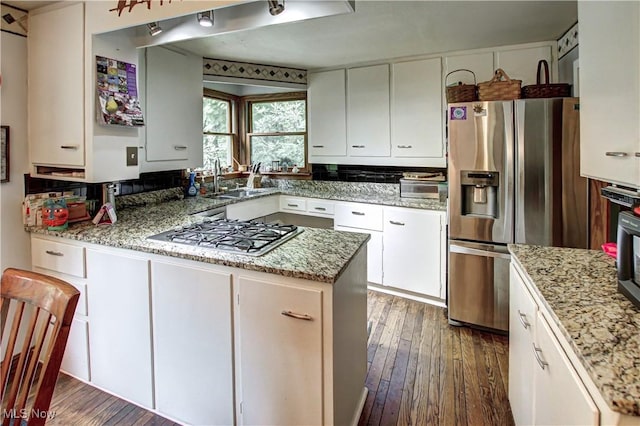 3366 Darrow Rd, Stow, OH 44224 - kitchen with appliances with stainless steel finishes, hardwood / wood-style floors, white cabinetry, and a peninsula