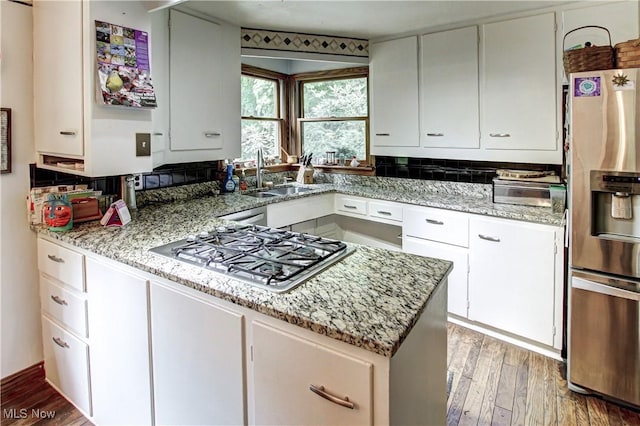 3366 Darrow Rd, Stow, OH 44224 - kitchen with stainless steel appliances, light wood-type flooring, white cabinetry, light stone countertops, and a peninsula