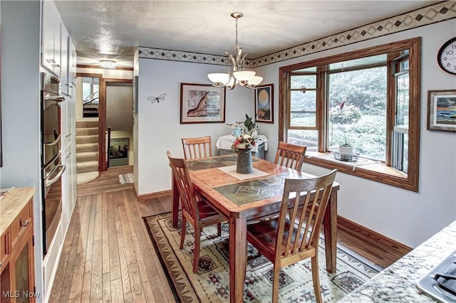 3366 Darrow Rd, Stow, OH 44224 - dining area featuring light wood-style floors, a chandelier, and healthy amount of natural light