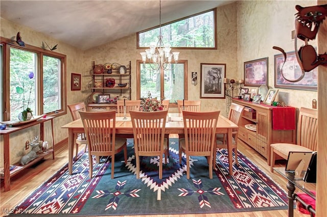 3366 Darrow Rd, Stow, OH 44224 - dining space with vaulted ceiling, wood finished floors, and a chandelier