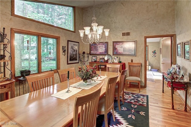 3366 Darrow Rd, Stow, OH 44224 - dining room with a high ceiling, wood finished floors, and a chandelier