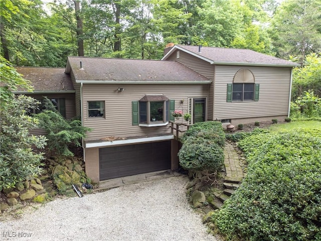 3366 Darrow Rd, Stow, OH 44224 - tri-level home with an attached garage, driveway, roof with shingles, and a chimney