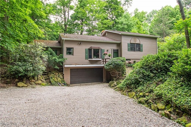 3366 Darrow Rd, Stow, OH 44224 - tri-level home with an attached garage, gravel driveway, and roof with shingles