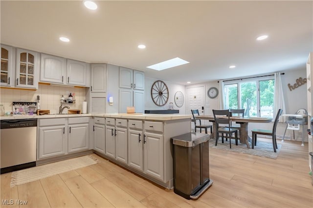 7080 Wren Ave NW, North Canton, OH 44720 - kitchen with stainless steel dishwasher, a skylight, light wood-type flooring, light countertops, and recessed lighting