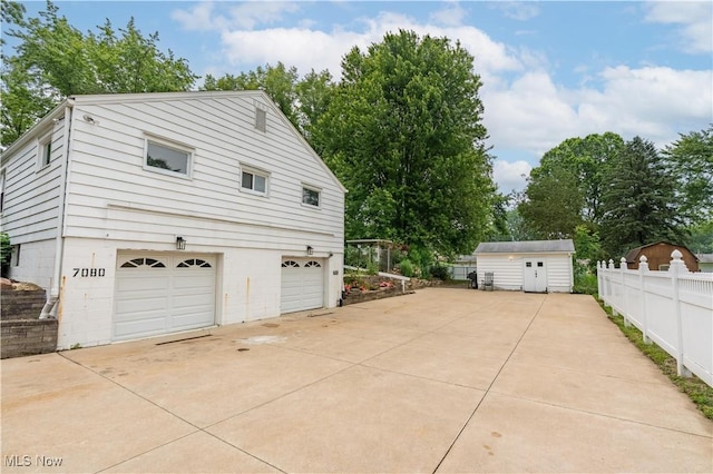 7080 Wren Ave NW, North Canton, OH 44720 - view of property exterior featuring a garage, a storage unit, and driveway