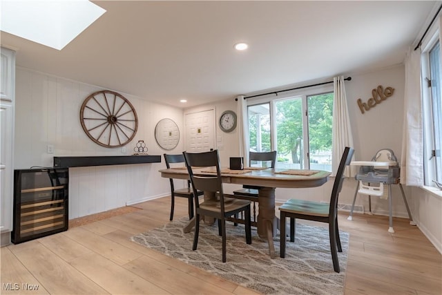 7080 Wren Ave NW, North Canton, OH 44720 - dining space featuring beverage cooler, light wood-style flooring, a skylight, and recessed lighting
