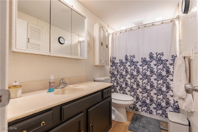 7080 Wren Ave NW, North Canton, OH 44720 - full bathroom with vanity, wood finished floors, curtained shower, and tile walls