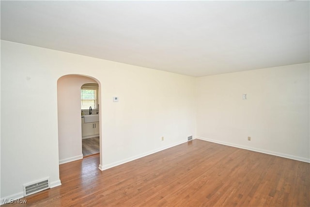 7673 N Lima Rd, Poland, OH 44514 - unfurnished room featuring arched walkways and wood finished floors