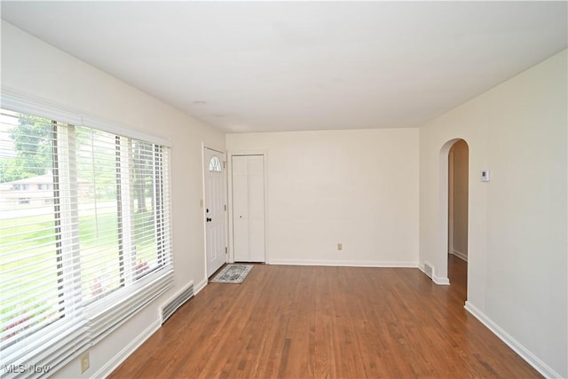 7673 N Lima Rd, Poland, OH 44514 - empty room featuring healthy amount of natural light, wood finished floors, and arched walkways