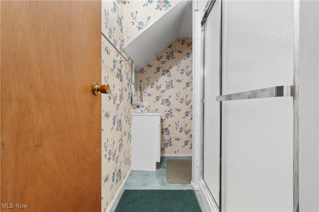 285 Berwin Pl, Munroe Falls, OH 44262 - bathroom with wallpapered walls, lofted ceiling, vanity, and a shower with door