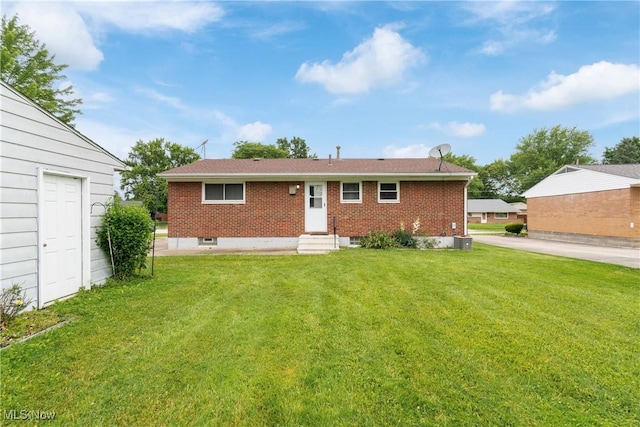 285 Berwin Pl, Munroe Falls, OH 44262 - rear view of house featuring brick siding, a lawn, and entry steps