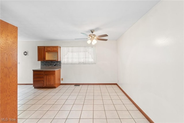 285 Berwin Pl, Munroe Falls, OH 44262 - kitchen with ceiling fan, backsplash, and brown cabinetry