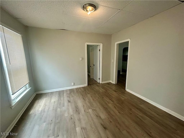 3180 W 90th St, Cleveland, OH 44102 - empty room featuring wood finished floors and a paneled ceiling