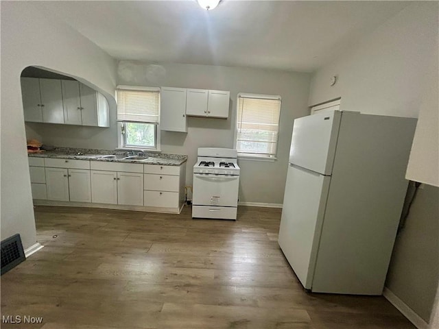 3180 W 90th St, Cleveland, OH 44102 - kitchen with white appliances, wood finished floors, and white cabinetry