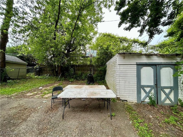 3180 W 90th St, Cleveland, OH 44102 - view of patio / terrace featuring a storage shed, outdoor dining space, and a detached carport