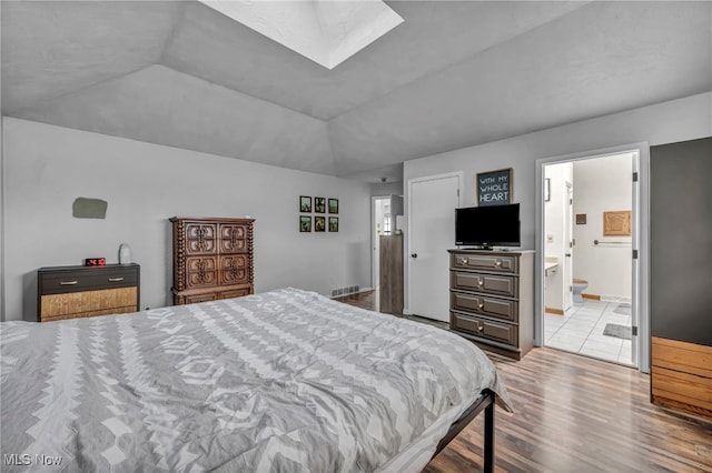 5065 Broadway, Lorain, OH 44052 - bedroom featuring wood finished floors, a skylight, vaulted ceiling, and ensuite bathroom