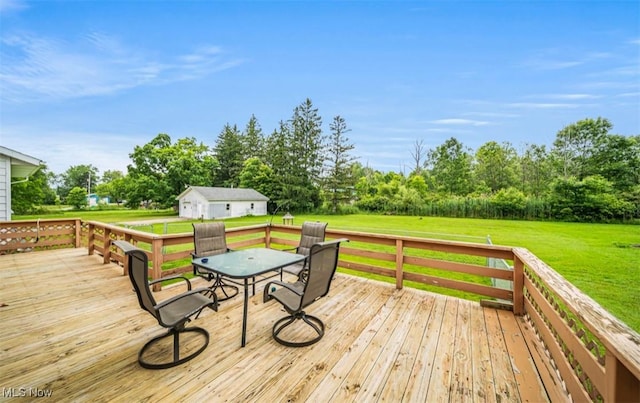 1518 State Route 46 N, Jefferson, OH 44047 - wooden deck with outdoor dining space, a lawn, an outbuilding, and view of scattered trees