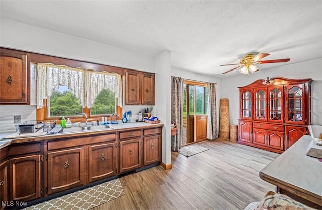 1518 State Route 46 N, Jefferson, OH 44047 - kitchen featuring ceiling fan, light countertops, light wood-style floors, and a textured ceiling