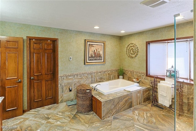 2307 Deerpath Dr, Sandusky, OH 44870 - full bath with marble tiled flooring, a bath, tile walls, a wainscoted wall, and recessed lighting