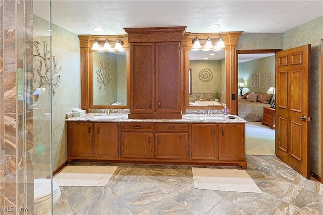 2307 Deerpath Dr, Sandusky, OH 44870 - ensuite bathroom featuring double vanity, a textured ceiling, and decorative columns