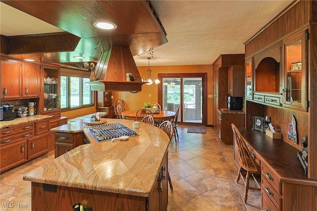 2307 Deerpath Dr, Sandusky, OH 44870 - kitchen featuring stainless steel gas stovetop, brown cabinetry, and plenty of natural light