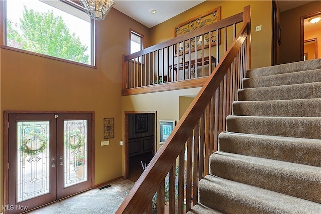 2307 Deerpath Dr, Sandusky, OH 44870 - foyer entrance featuring stairway, french doors, a towering ceiling, and stone finish floors