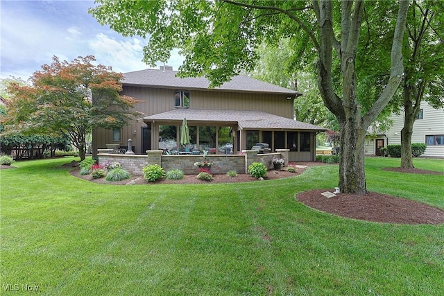 2307 Deerpath Dr, Sandusky, OH 44870 - back of property with a lawn, a shingled roof, a patio, and a chimney