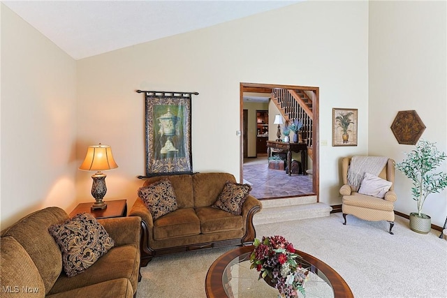 2307 Deerpath Dr, Sandusky, OH 44870 - carpeted living room featuring vaulted ceiling and baseboards