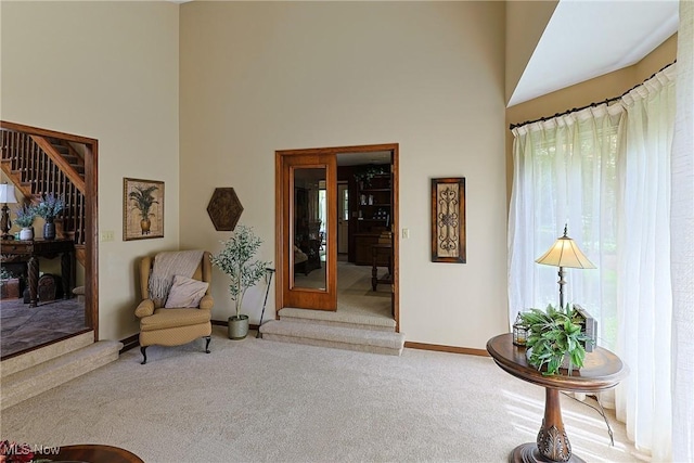 2307 Deerpath Dr, Sandusky, OH 44870 - living area with a high ceiling, carpet floors, and stairs