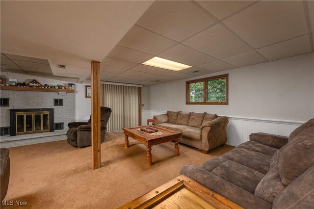 2436 Woodlawn Dr NW, Dover, OH 44622 - living area with a fireplace, a paneled ceiling, carpet flooring, and wainscoting
