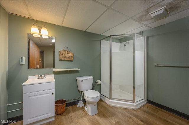 2436 Woodlawn Dr NW, Dover, OH 44622 - bathroom featuring wood finished floors, a stall shower, vanity, and a drop ceiling