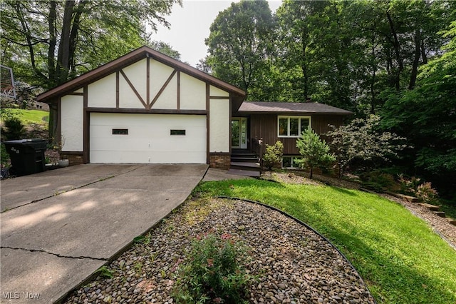 2436 Woodlawn Dr NW, Dover, OH 44622 - view of front facade with driveway, an attached garage, and a front lawn