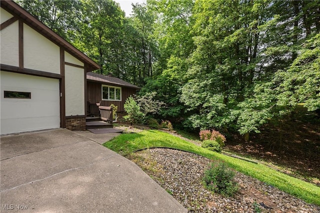 2436 Woodlawn Dr NW, Dover, OH 44622 - view of yard featuring concrete driveway and a garage