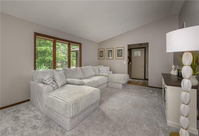 2436 Woodlawn Dr NW, Dover, OH 44622 - carpeted living room with lofted ceiling and baseboards