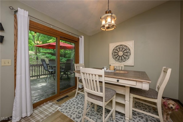 2436 Woodlawn Dr NW, Dover, OH 44622 - dining area with a chandelier, lofted ceiling, and wood finished floors