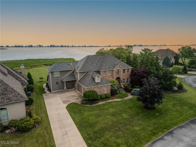 854 Crosstree Ln, Sandusky, OH 44870 - view of front of property with a garage, concrete driveway, a water view, and a yard