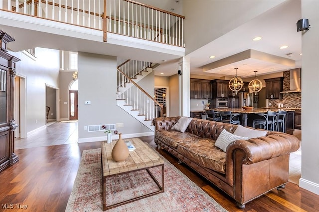 854 Crosstree Ln, Sandusky, OH 44870 - living room with a towering ceiling, wood finished floors, stairway, recessed lighting, and decorative columns