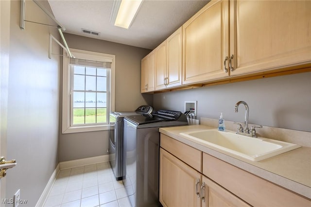 854 Crosstree Ln, Sandusky, OH 44870 - washroom featuring cabinet space, separate washer and dryer, and light tile patterned flooring