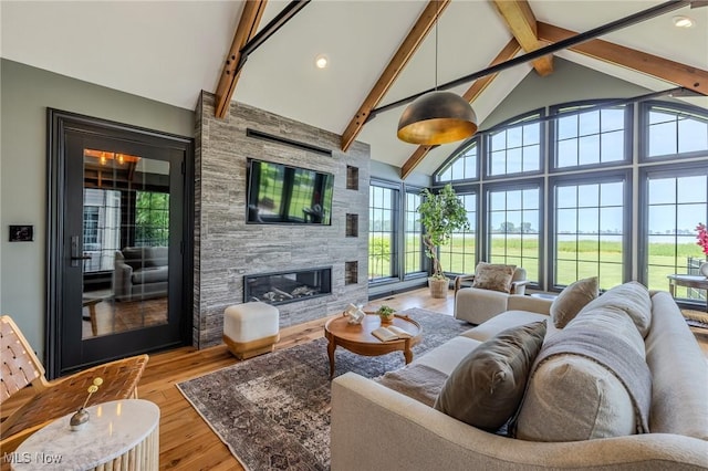 854 Crosstree Ln, Sandusky, OH 44870 - living area featuring beamed ceiling, light wood finished floors, a large fireplace, high vaulted ceiling, and recessed lighting
