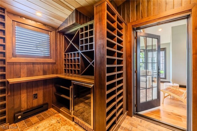 854 Crosstree Ln, Sandusky, OH 44870 - wine room with brick flooring, wood walls, wine cooler, recessed lighting, and a sauna