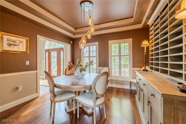 854 Crosstree Ln, Sandusky, OH 44870 - dining area with a tray ceiling and dark wood-style flooring
