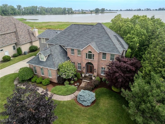 854 Crosstree Ln, Sandusky, OH 44870 - view of front of home with brick siding, a water view, and a front yard