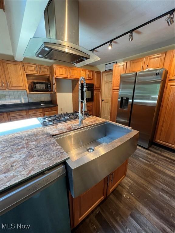 3290 NW Sweitzer St NW, Uniontown, OH 44685 - kitchen featuring stainless steel appliances, island range hood, dark wood-type flooring, rail lighting, and backsplash