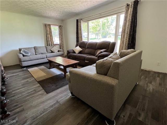 3290 NW Sweitzer St NW, Uniontown, OH 44685 - living area with dark wood-style flooring and a textured ceiling